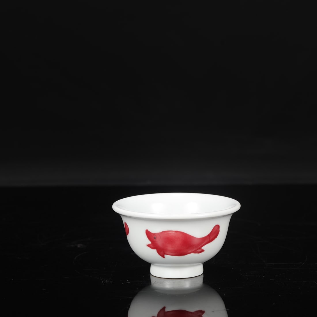 A Ming Dynasty Xuande period underglaze red fish-patterned cup, formerly in the collection.: Height: 5 cm, Mouth Diameter: 9.5 cm