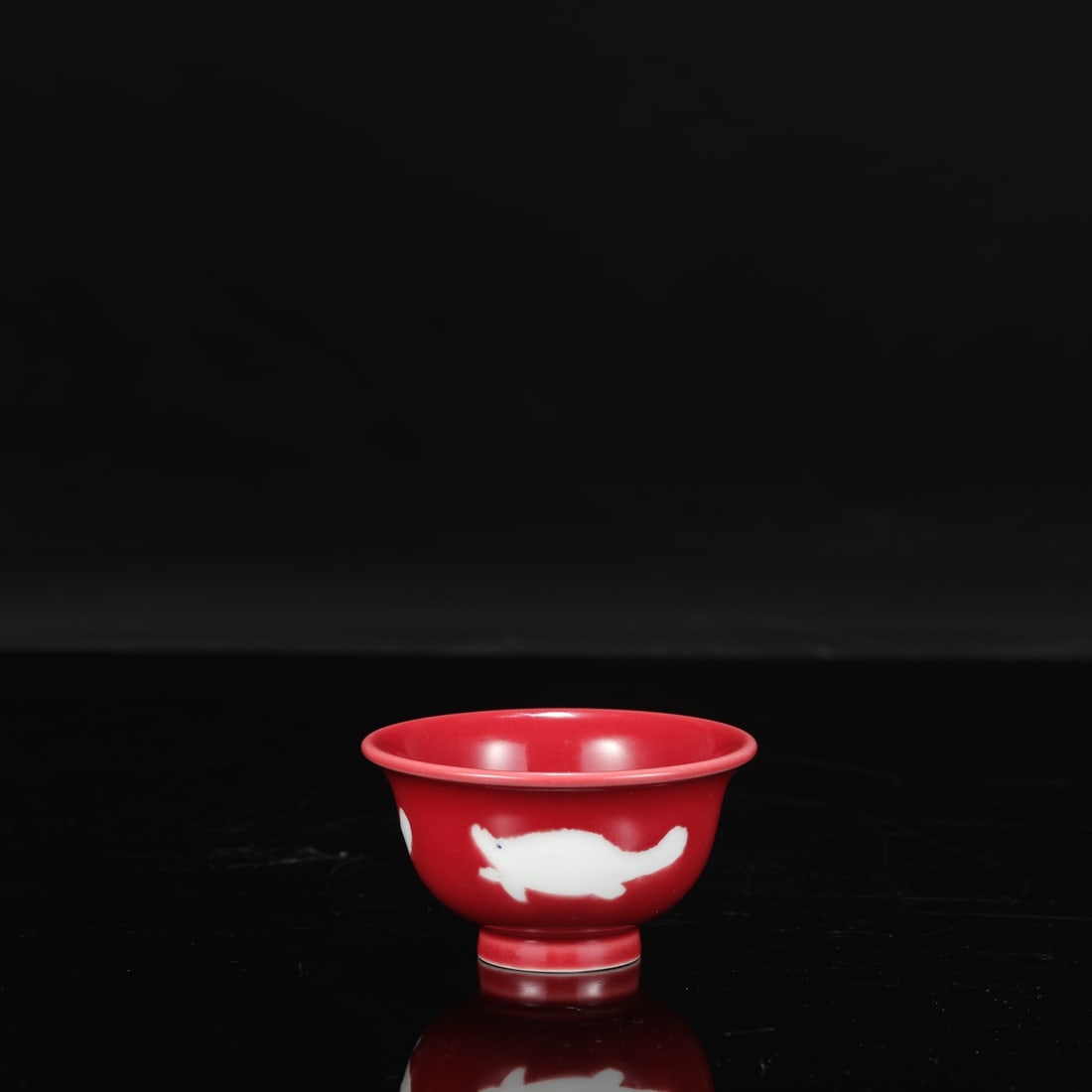 A Ming Dynasty Xuande period ruby-red fish-patterned hand-pressed cup, formerly in the collection.: Height: 5.5 cm, Mouth Diameter: 9.5 cm