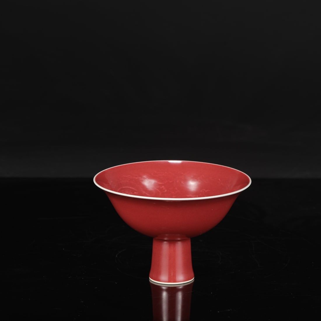 A Ming Dynasty Yongle period (1620s) sacrificial red glaze stem bowl with incised dragon design.: Height: 10 cm, Mouth diameter: 15.5 cm