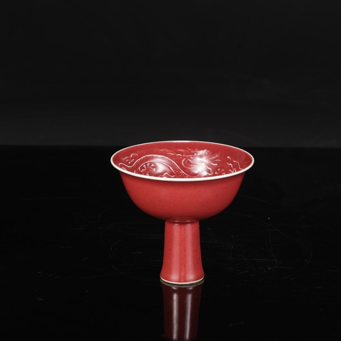 A Yuan dynasty sacrificial red glaze stem cup with incised cloud and dragon design, formerly in a: Height: 10.5 cm, Mouth diameter: 12 cm
