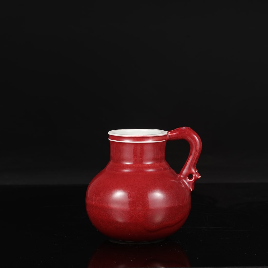 A Ming Dynasty Xuande period gem-red glazed dragon-handled flower ewer, formerly in the collection.: Height: 15.5 cm, Mouth diameter: 7.5 cm, Belly diameter: 13 cm