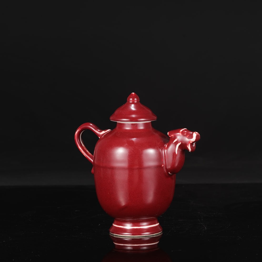 A large Ming Dynasty Xuande period ruby-red glazed ewer, formerly in the collection.: Height: 18.5 cm, Mouth diameter: 4.5 cm, Belly diameter: 10 cm