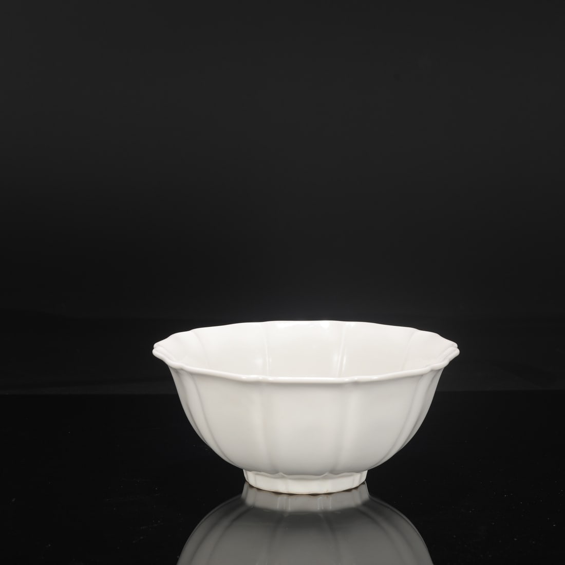 A large, deep-bodied, melon-shaped bowl with a sweet white glaze from the Yongle period of the Ming: Height: 10 cm, Diameter: 23 cm