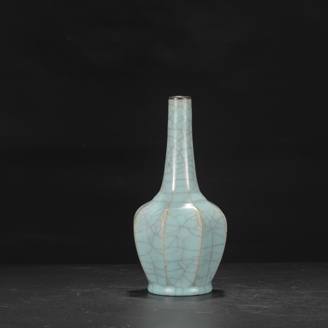 A Southern Song Dynasty official kiln celadon octagonal vase with a silver rim, formerly in the: Height: 22.5 cm, Mouth diameter: 2.5 cm, Belly diameter: 10.5 cm