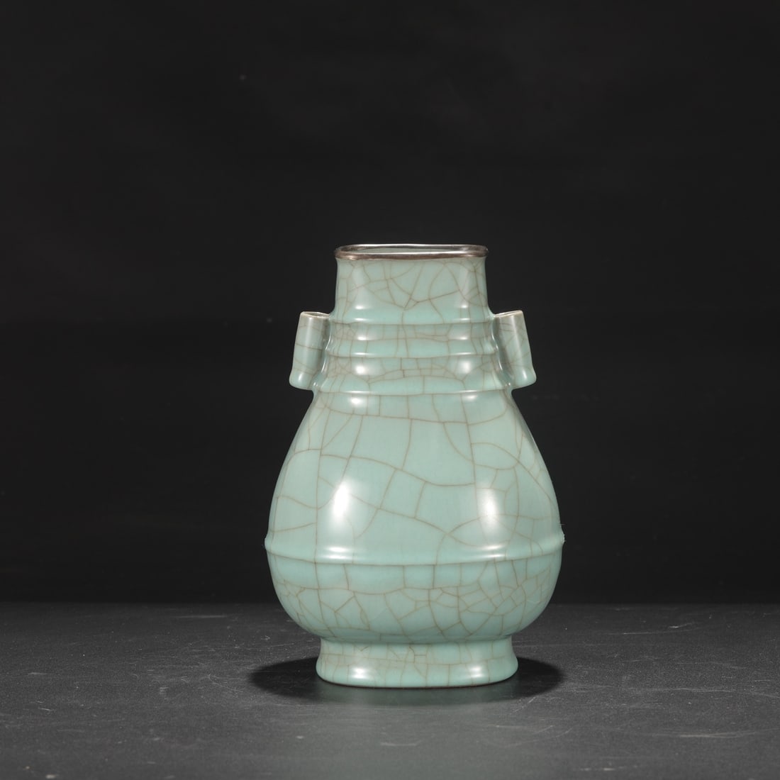 A Southern Song Dynasty official kiln celadon vase with a silver mouth and large handles, inscribed: Height: 24 cm, Mouth diameter: 8 cm, Belly diameter: 15.5 cm