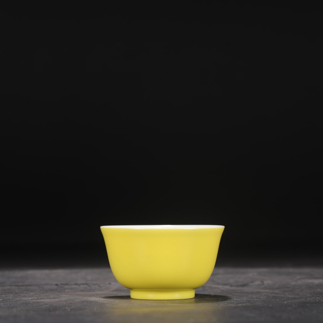 A Qing Dynasty Yongzheng period pale yellow glazed tea bowl, formerly in the collection.: Height: 4.5 cm, Mouth Diameter: 7.5 cm