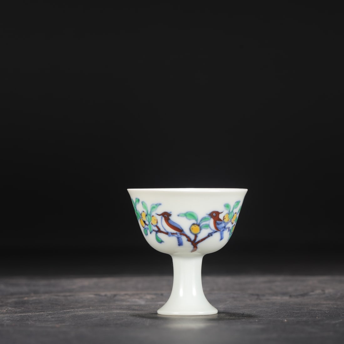 A Ming Dynasty Chenghua period doucai (enamel overglaze) stem cup with floral, bird, and fruit: Height: 7 cm, Mouth Diameter: 6.5 cm