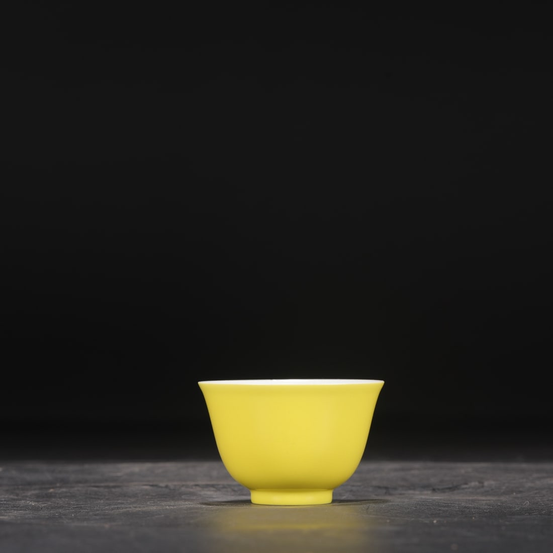 A Qing Dynasty Yongzheng period pale yellow glazed tea bowl, formerly in the collection.: Height: 4.5 cm, Mouth Diameter: 7.5 cm