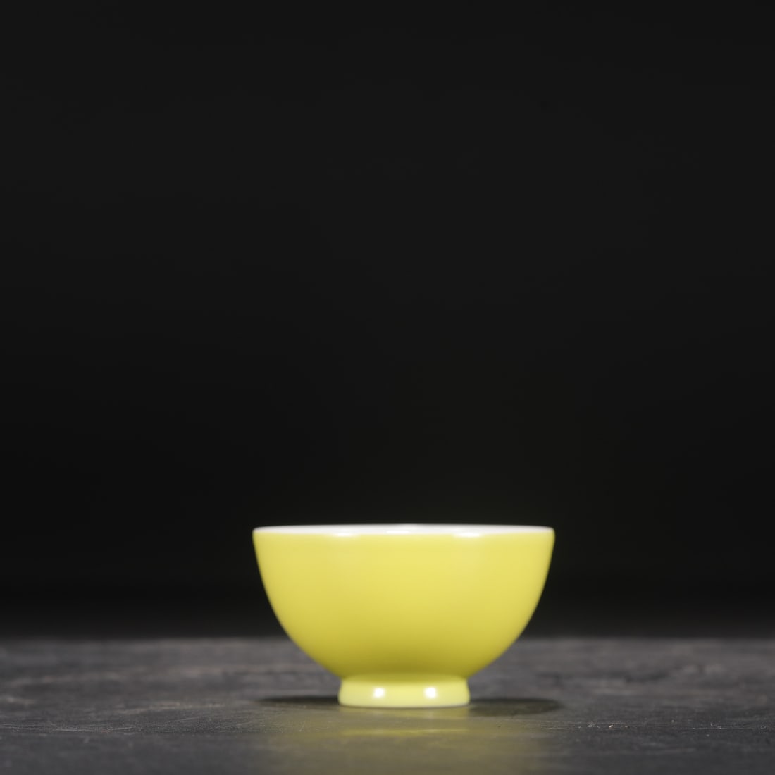 A Qing Dynasty Yongzheng period pale yellow glazed tea bowl, formerly in the collection.: Height: 4.5 cm, Mouth Diameter: 7.5 cm
