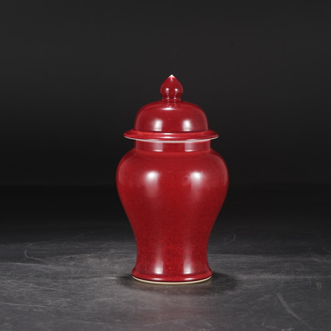 A Ming Dynasty Xuande period ruby-red glazed large covered jar, formerly in the collection.: Dimensions: Height 25 cm, Mouth diameter 9 cm, Belly diameter 13.5 cm.