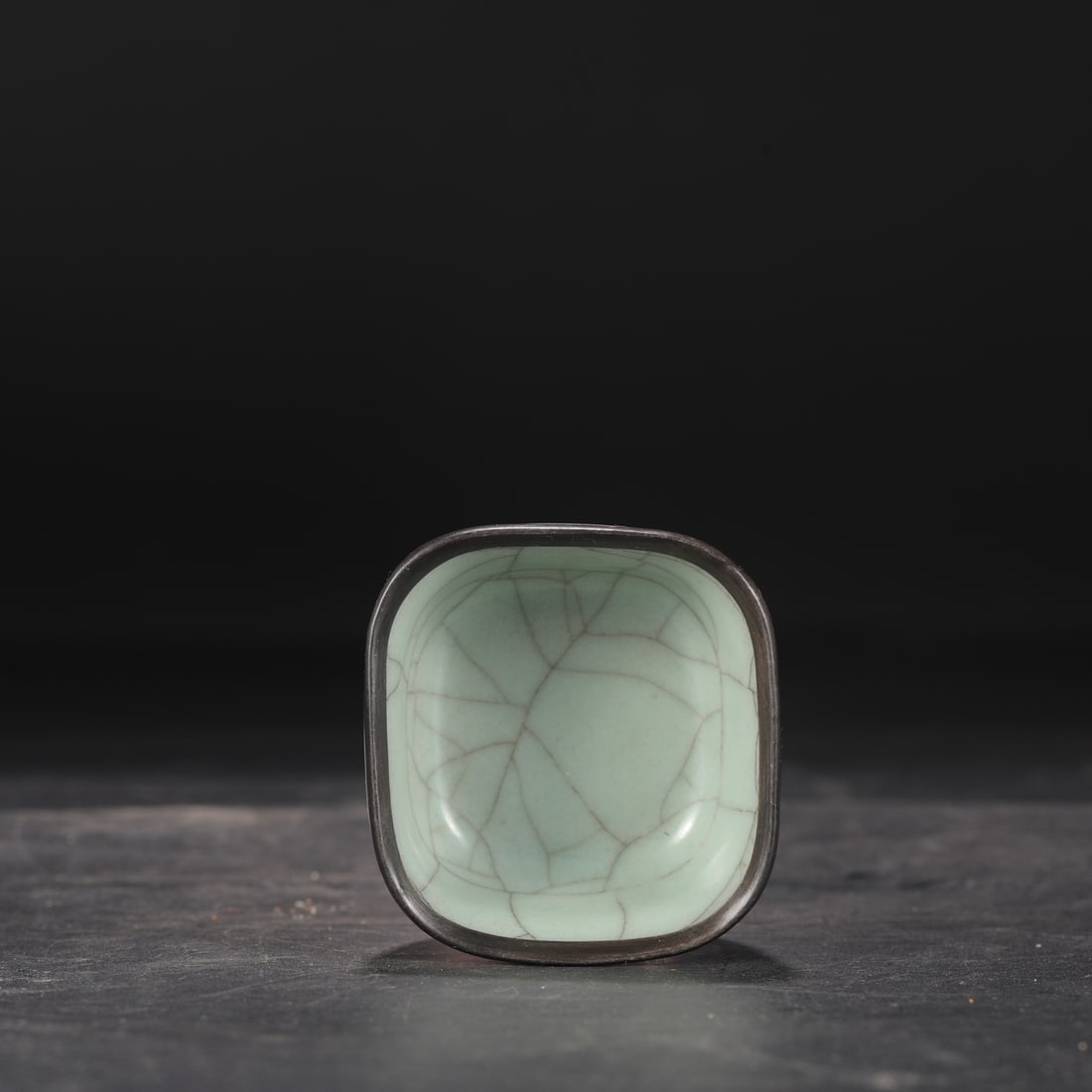 A Southern Song Dynasty official kiln celadon tea bowl with a silver rim, formerly in the: Dimensions: Height 3.5 cm, Diameter 7 cm.