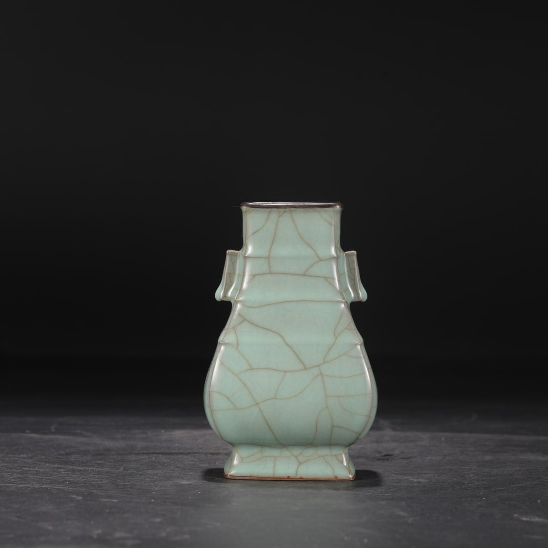 A Southern Song Dynasty official kiln celadon vase with silver rim and tubular handles, inscribed: Dimensions: Height 15.5 cm, Mouth diameter 5.5 cm, Belly diameter 9 cm.
