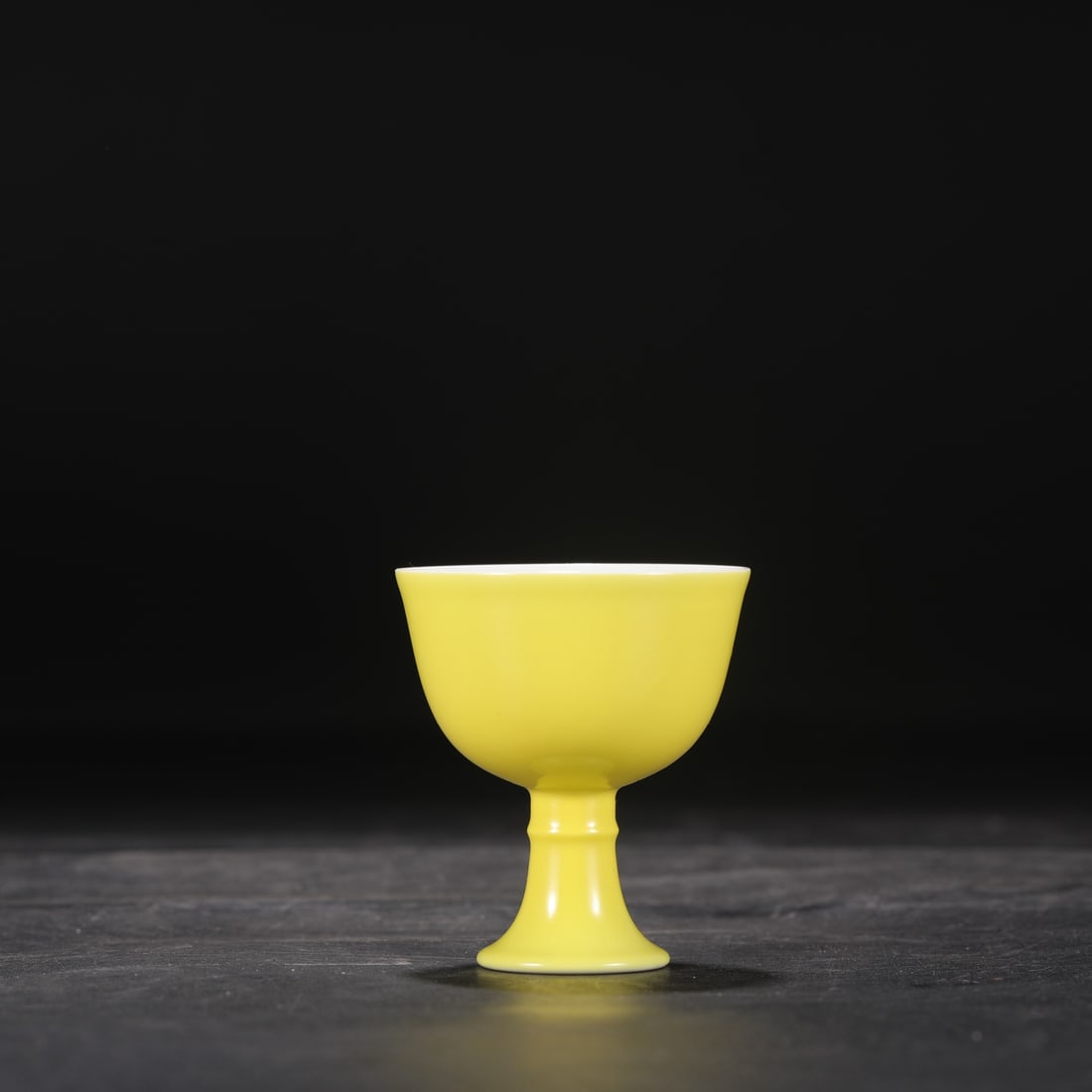A Qing Dynasty Yongzheng period pale yellow glazed stem cup,: 7 cm high and 6.3 cm in diameter.