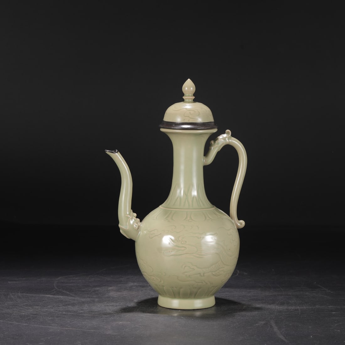 A large Tang Dynasty Yue ware celadon ewer with carved dragon design and silver inlay, formerly from (1 of 8)