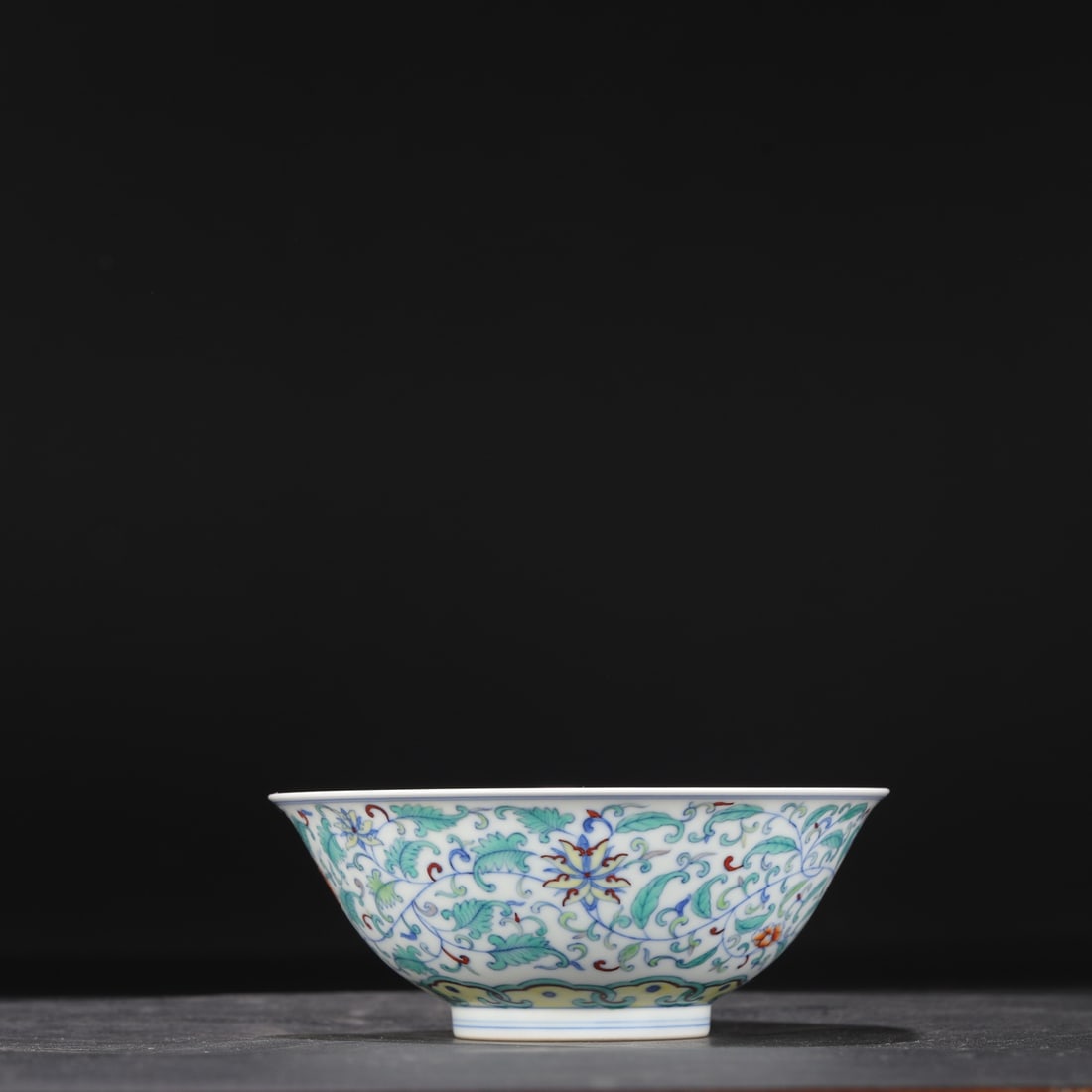 A Qing Dynasty Yongzheng period doucai (enamel overglaze) palace bowl with a design of intertwined: 6 cm high and 15 cm in diameter.