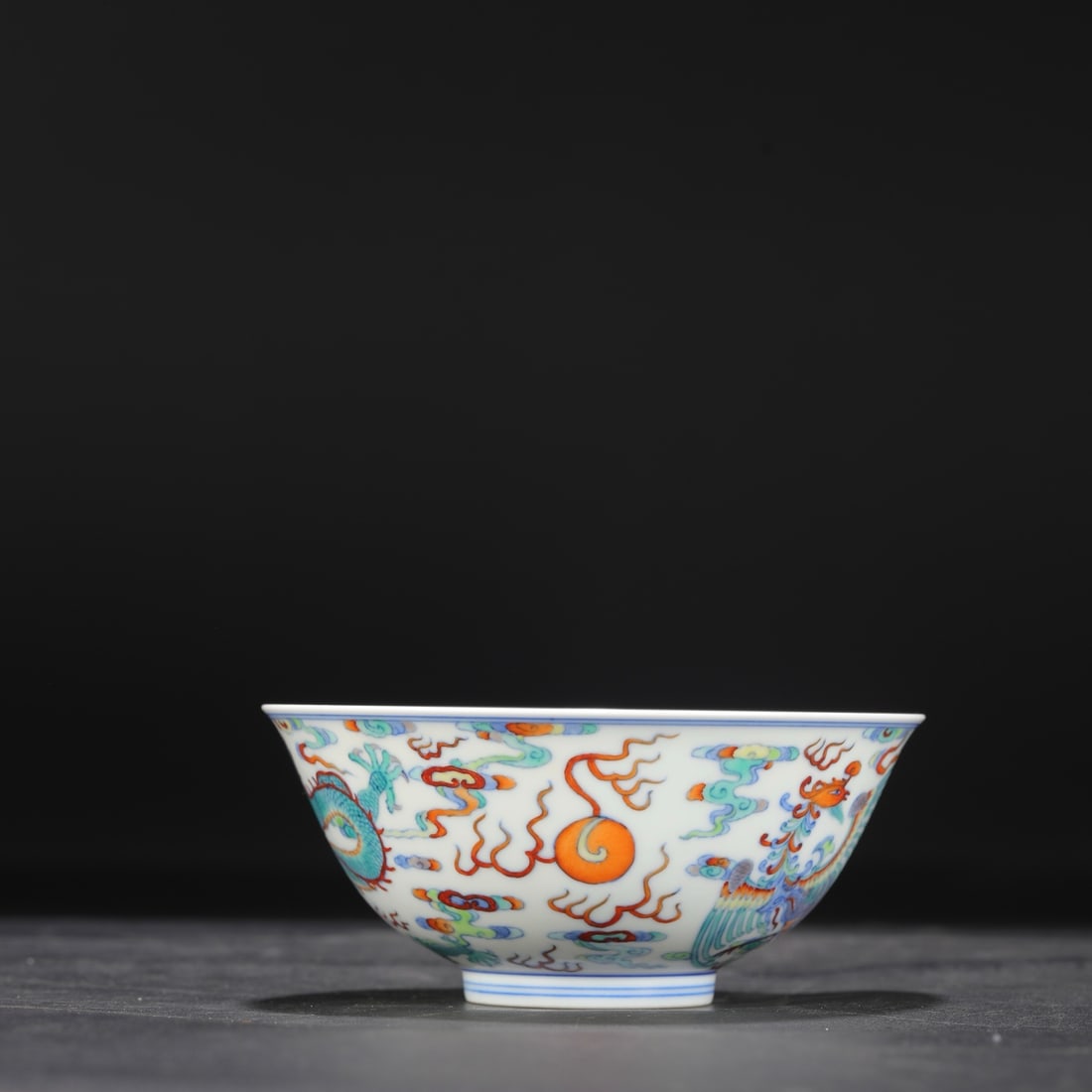 A Qing Dynasty Yongzheng period doucai palace bowl with dragon and phoenix design, formerly in the (1 of 8)