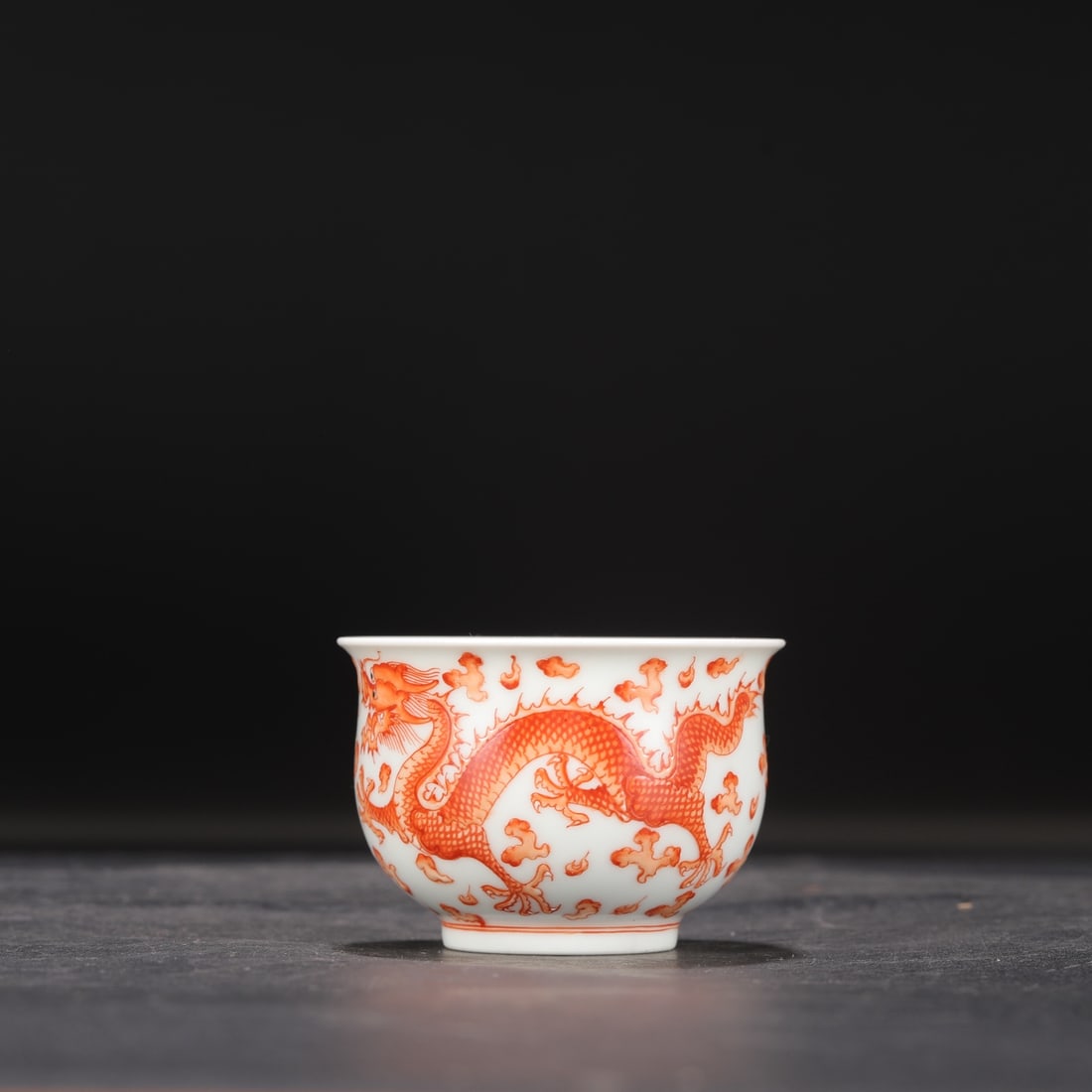 A Qing Dynasty Qianlong period iron-red dragon and cloud design Luohan cup, formerly in the: Dimensions: Height 5.5 cm, Mouth diameter 8 cm.