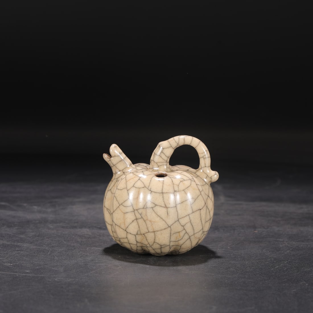 A Northern Song Dynasty Ge ware melon-shaped water dropper ewer with a beige glaze, formerly in the: Dimensions: Height 10 cm, Belly diameter 9 cm.
