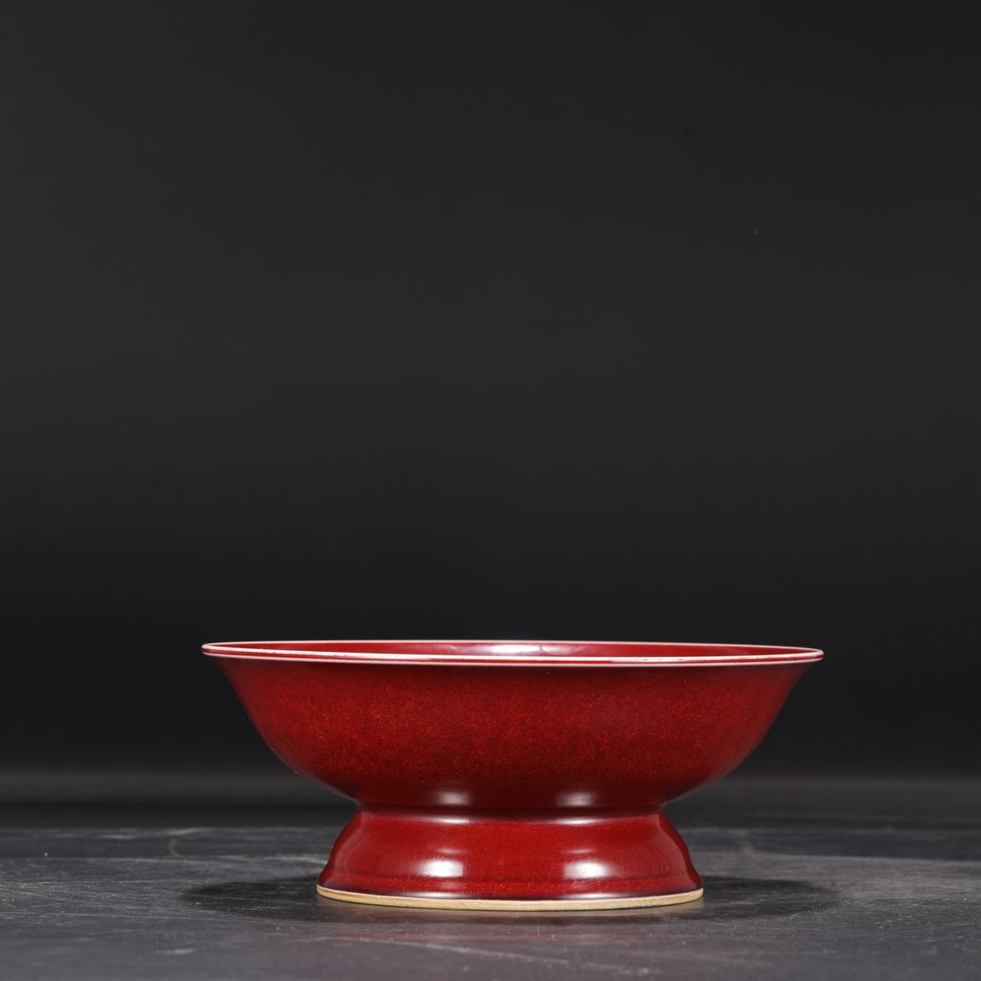 A Ming Dynasty Xuande period gem-red glazed high-footed fruit dish: 8.5 cm high and 21 cm in diameter.