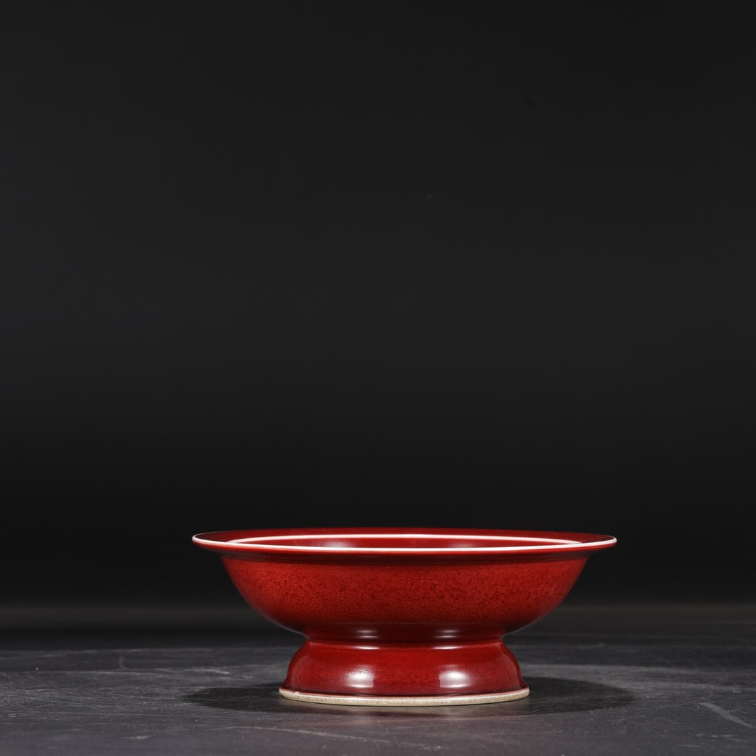 A Ming Dynasty Xuande period ruby-red glazed fruit dish with a folded rim, formerly in the: Dimensions: Height 8.5 cm, Diameter 22 cm.
