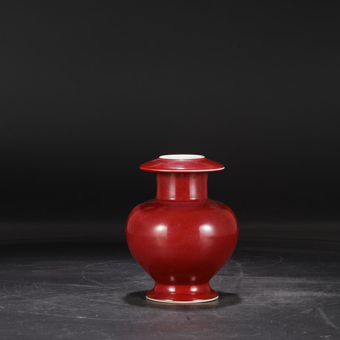 A large pomegranate-shaped vase with a gem-red glaze from the Xuande period of the Ming dynasty,: Dimensions: Height 18.5 cm, Mouth diameter 5 cm, Belly diameter 14 cm.
