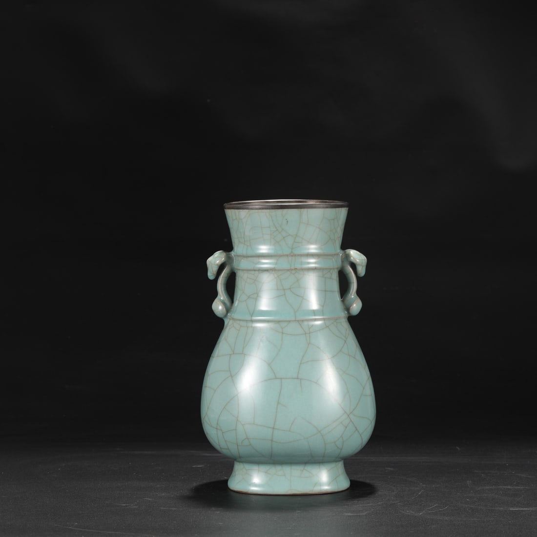 A Southern Song Dynasty official kiln celadon vase with a silver rim and large, ruyi-shaped handles,: Dimensions: Height 27 cm, Mouth Diameter 11.5 cm, Belly Diameter 16 cm.