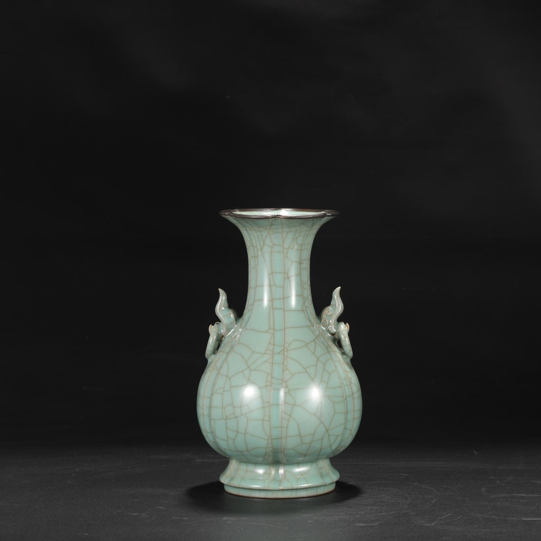 A Southern Song Dynasty official kiln celadon melon-shaped vase with a silver rim and elephant-ear: Dimensions: Height 26.5 cm, Mouth diameter 11.5 cm, Belly diameter 15 cm.