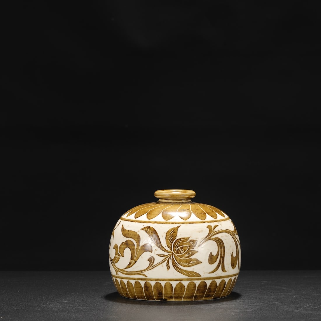 A Northern Song Dynasty Ding ware white-glazed pomegranate-shaped vase with brown-painted carved: Dimensions: Height 12 cm, Mouth diameter 4.5 cm, Belly diameter 14.5 cm.