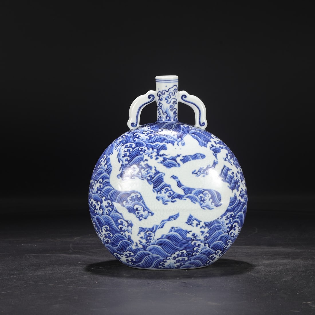 A Ming Dynasty Xuande period blue and white porcelain moon flask with carved sea dragon design, (1 of 8)