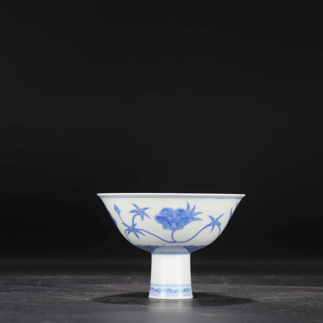 A Ming Dynasty Chenghua blue and white porcelain stem bowl with a scrolling floral design, formerly: Dimensions: Height 11 cm, Mouth Diameter 15.5 cm.