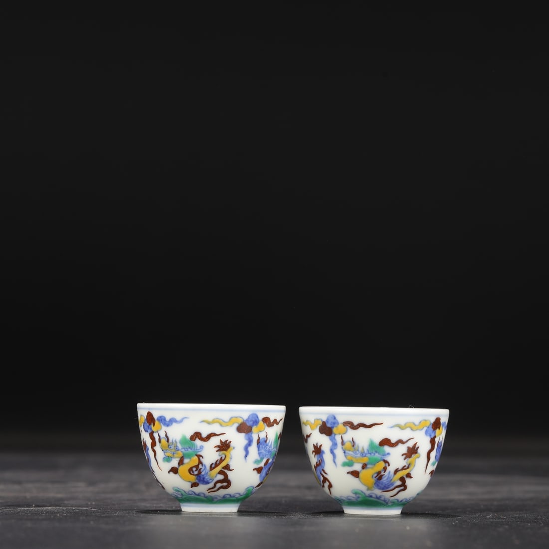 A pair of Ming Dynasty Chenghua Doucai (enamel overglaze) cups with cloud and dragon design,: Dimensions: Height 3.5 cm, Mouth Diameter 5 cm.