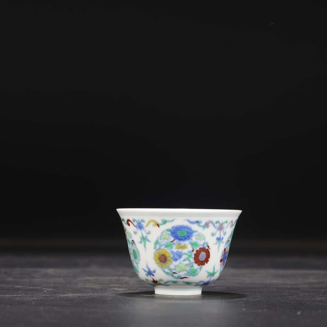 A Ming Dynasty Chenghua period doucai (enamel overglaze) bell-shaped cup with chrysanthemum design,: Dimensions: Height 5 cm, Mouth Diameter 7.8 cm.