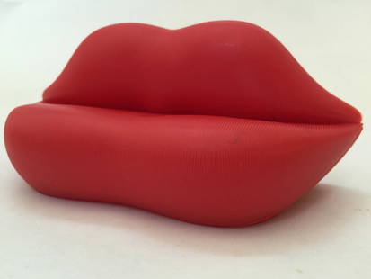 Salvador Dali "Lips" Sofa Desk Dsiplay: The "Lips Sofa" is a distinctive and iconic piece of furniture designed by Italian artist and designer Salvador DalÃ­ in 1936. Officially known as the "Bocca Sofa," it is sometimes referred