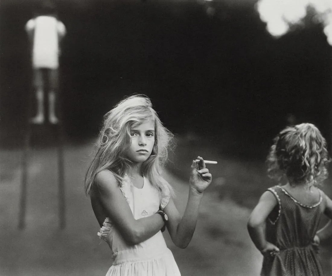 SALLY MANN "Candy Cigarette, 1989" Print: Sally Mann is a well-known American photographer known for her intimate and evocative photographs, often capturing moments within her own family. "Candy Cigarette, 1989" refers to one of her iconic ph