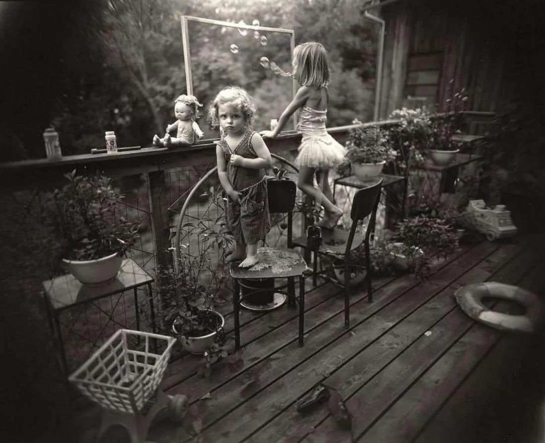Sally Mann "Blowing Bubbles, 1987" Print: Sally Mann is an American photographer known for her intimate and often controversial black-and-white photographs, primarily capturing her family members and the landscape of the American South. Born