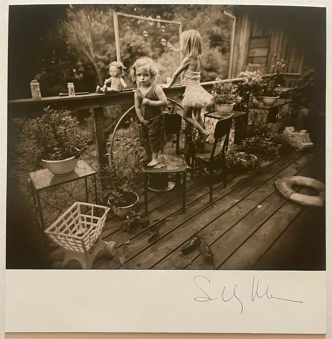 Sally Mann Signed "Blowing Bubbles, 1987" Print: Sally Mann is an American photographer known for her compelling and controversial work, particularly in the genre of documentary and fine art photography. Born in 1951 in Lexington, Virginia, Mann gai