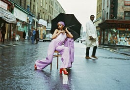 Armet Francis "Fashion Shoot Brixton Market" Print: Armet Francis (1937–2021) was a British photographer known for his powerful and insightful images that documented the lives and experiences of the Black community in Britain. Born in the Caribbean i