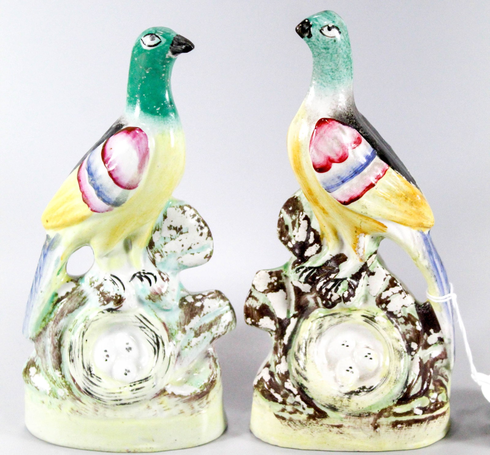 Pair of Staffordshire style birds: Pair of Staffordshire style birds with nests.