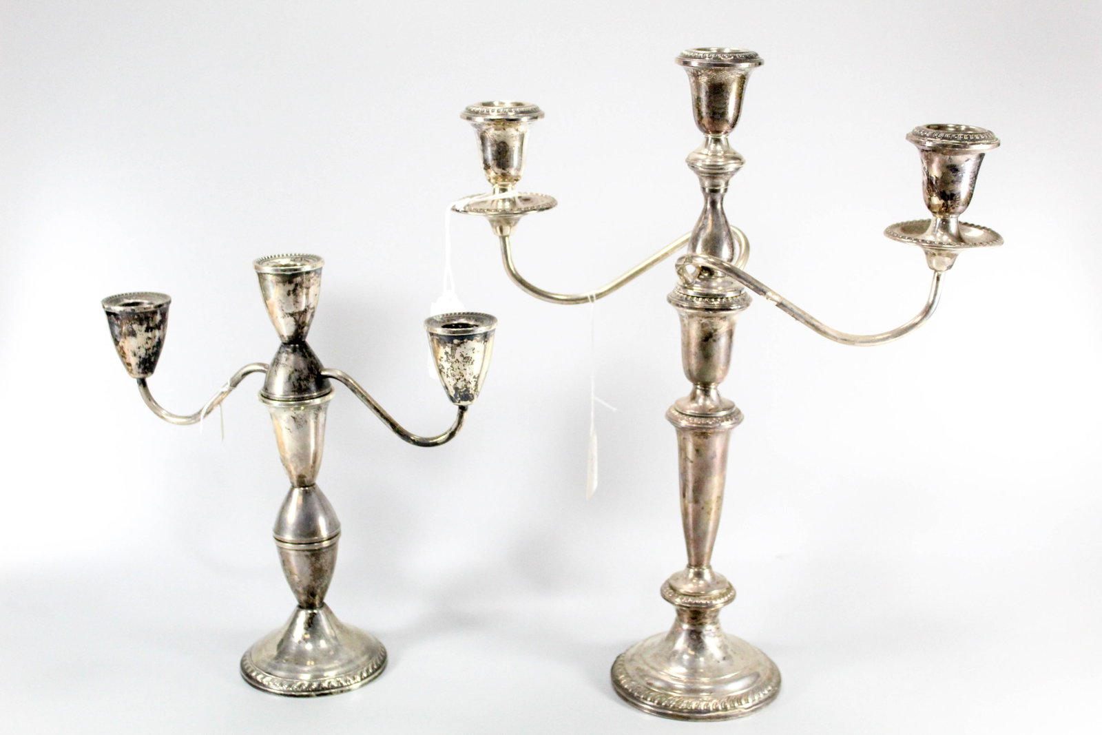 Pair of sterling silver weighted candelabras. One is marked "Duchin Operation".: Pair of sterling silver weighted candelabras. One is marked "Duchin Operation".