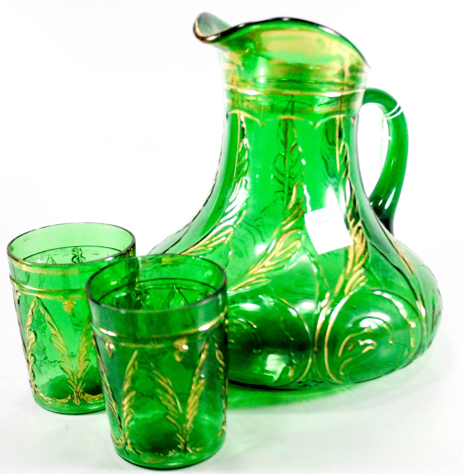 Emerald green waving quill pitcher and two matching glasses.: Emerald green waving quill pitcher and two matching glasses.