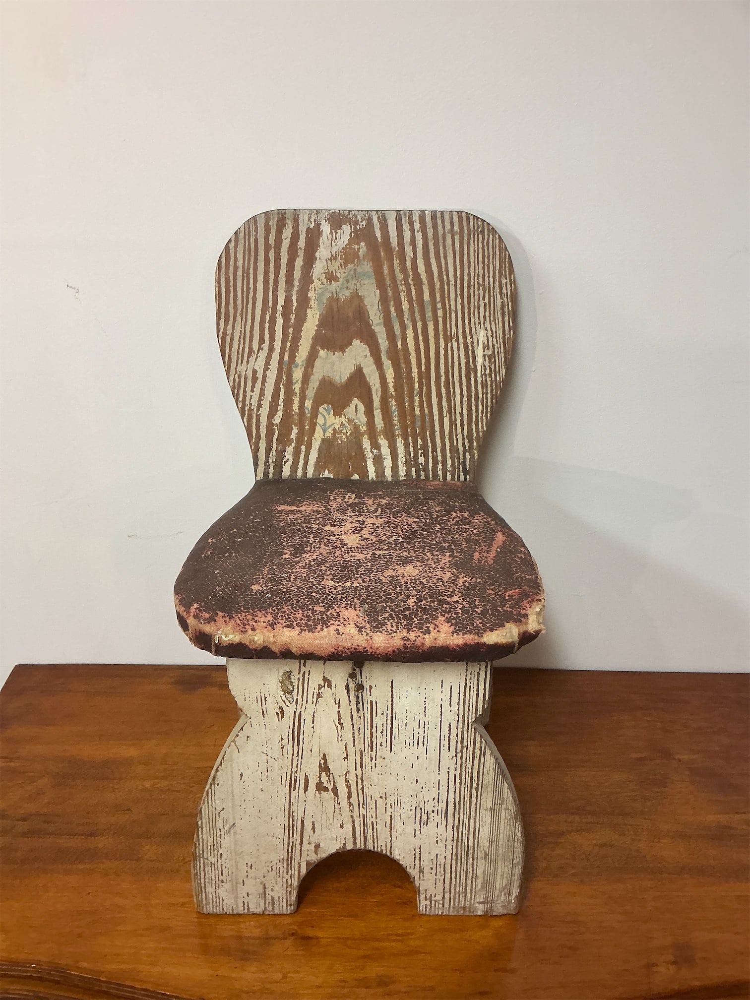 Antique Wooden Child’s Chair: This antique wooden child's chair showcases charming craftsmanship and rustic appeal. Made from solid wood, its timeless design features a beautifully grained backrest and a slightly worn seat,