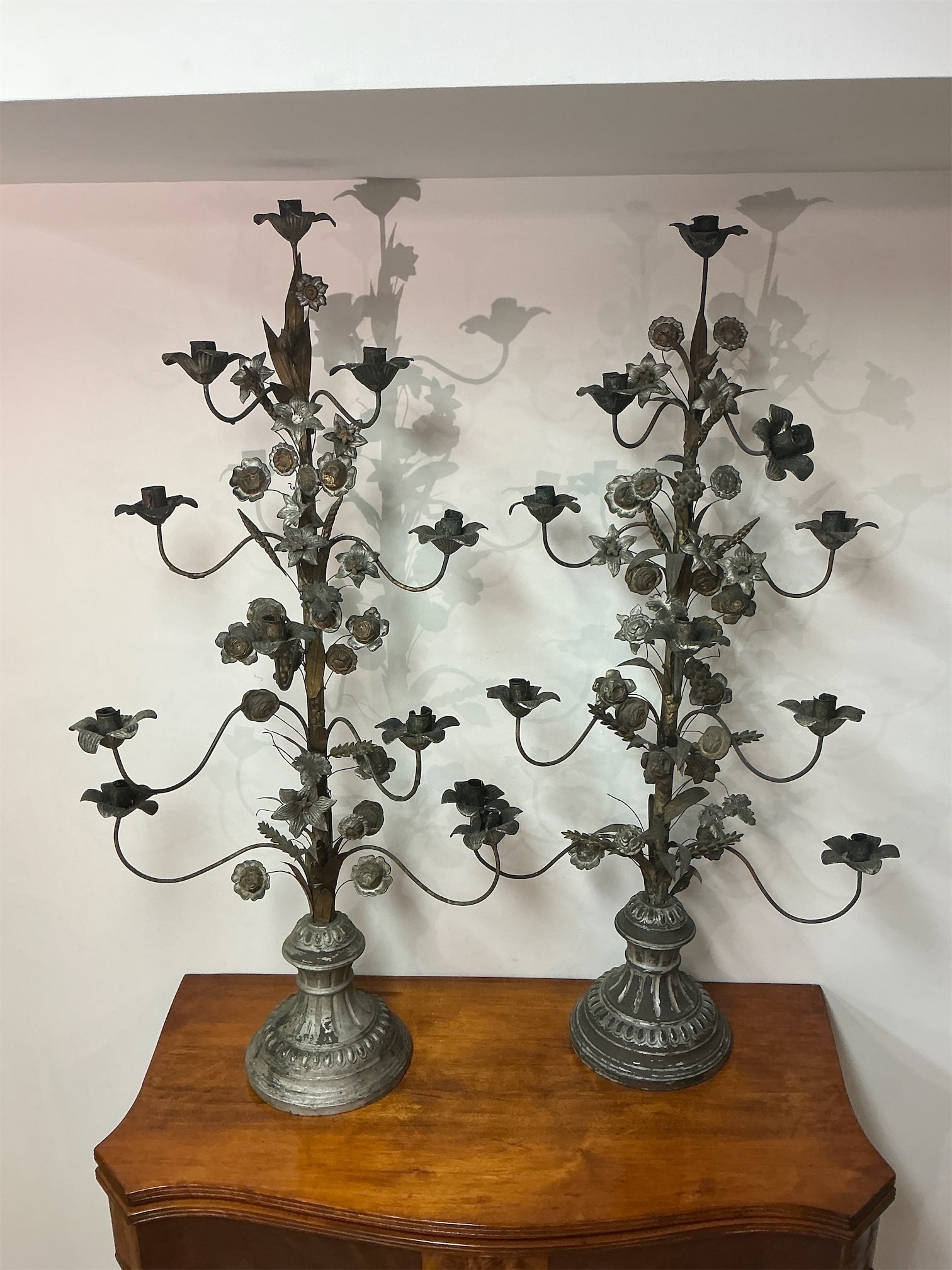 Antique Tole Candelabras: This exquisite pair of antique tole candelabras showcases intricate craftsmanship with a timeless design. Both pieces feature elegant floral motifs and a combination of candle holders that elegantly