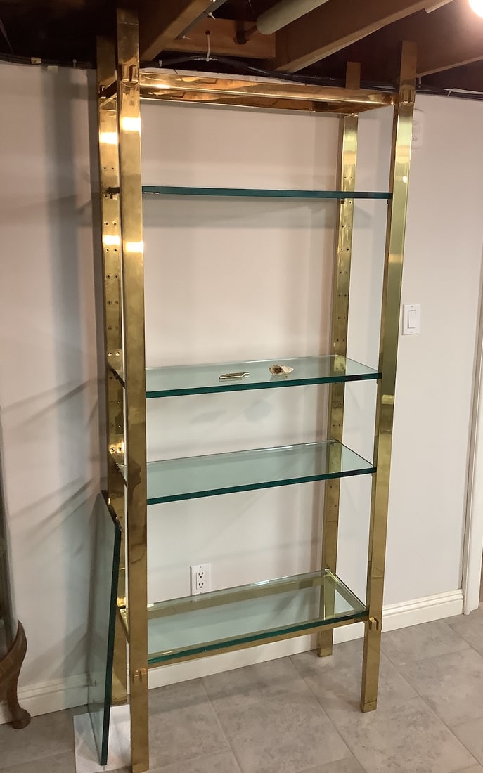 Etagere: This elegant etagere features a sleek design with a polished brass frame and multiple glass shelves, perfect for displaying books, decorative items, or collectibles. The open design allows for