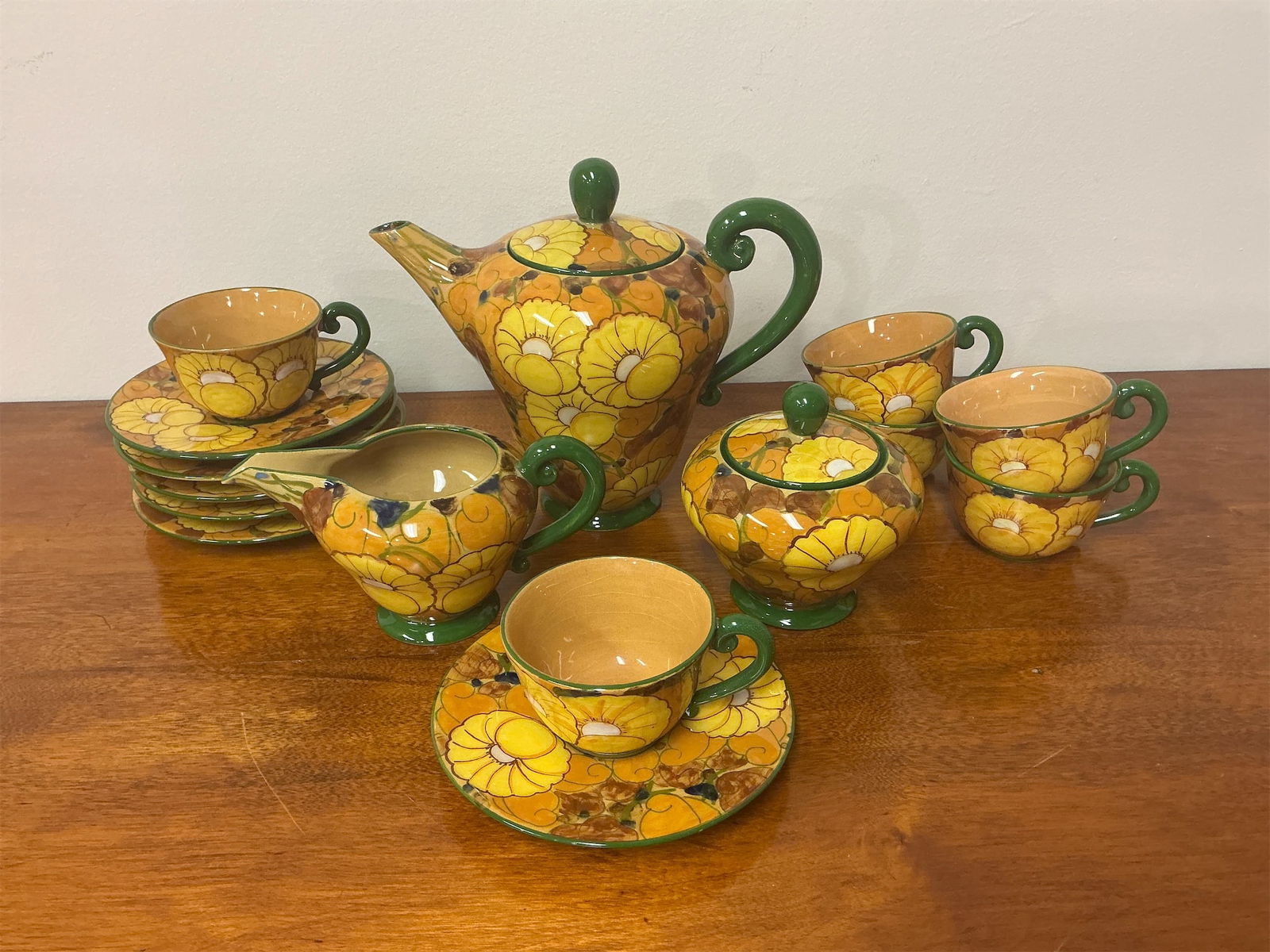 Vintage Italian Pottery tea set with Mougin tray: This stunning vintage Italian pottery tea set showcases exquisite hand-painted design featuring vibrant yellow flowers and green accents. The set includes a beautifully crafted teapot with an elegant