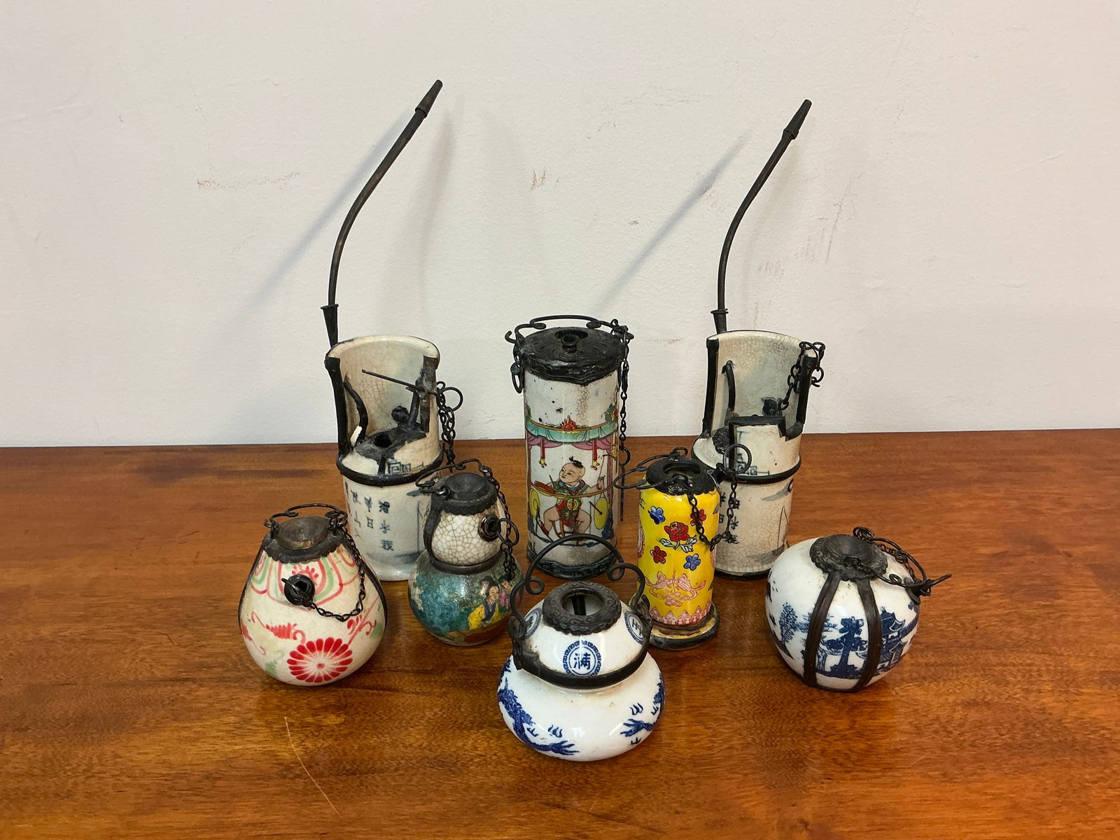 Set of 8 Chinese Opium Water Pipes: This set features eight intricately designed Chinese opium water pipes, each showcasing unique craftsmanship and cultural significance. The collection includes a variety of shapes and decorative