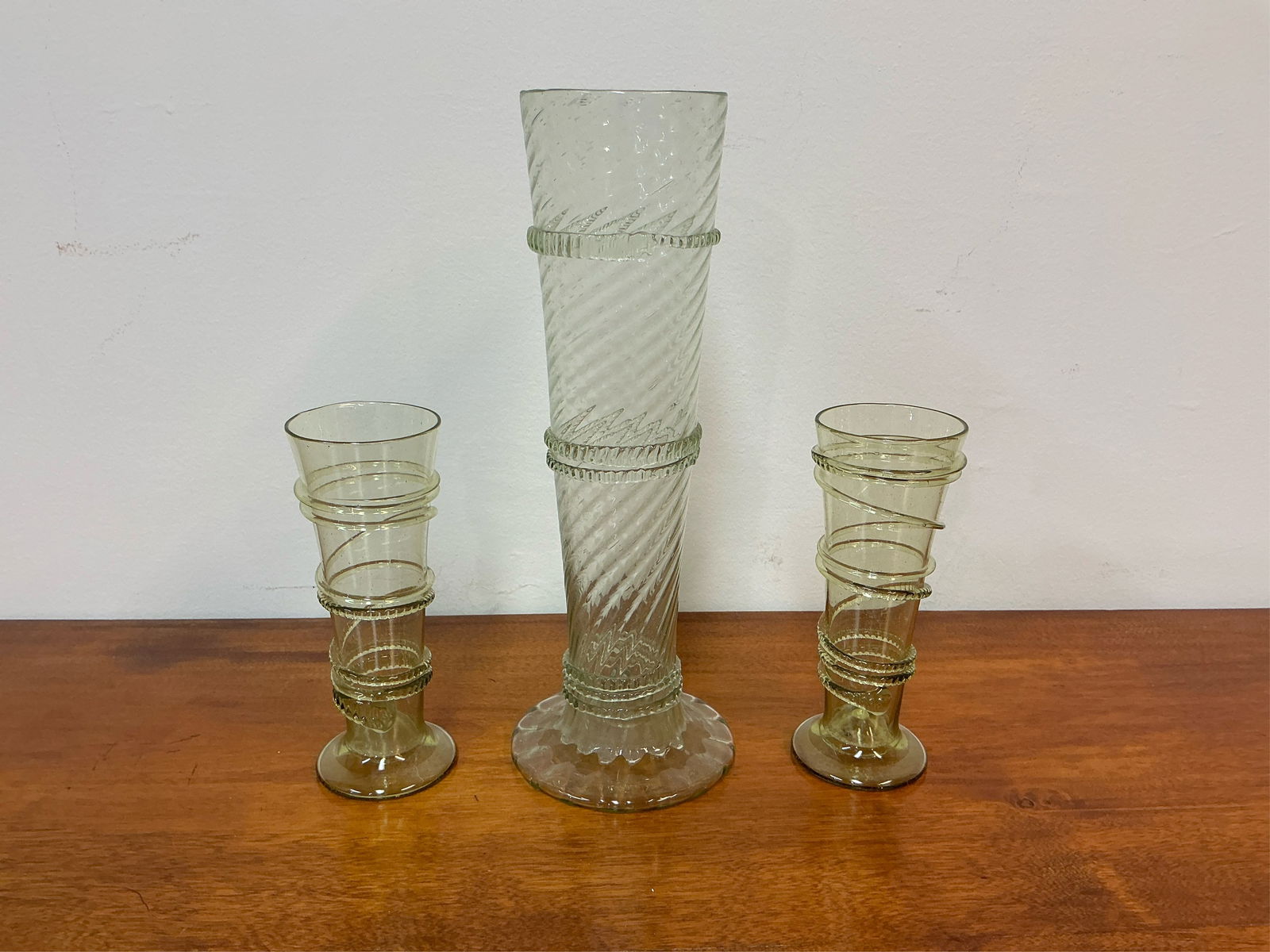 Vintage Juliska Celadon Green Signed Glass Vases - Set of 3: Set of 3 vintage Juliska celadon green glass vases, beautifully crafted and signed. Each vase showcases a unique design with an elegant spiral embellishment that adds a touch of sophistication. The