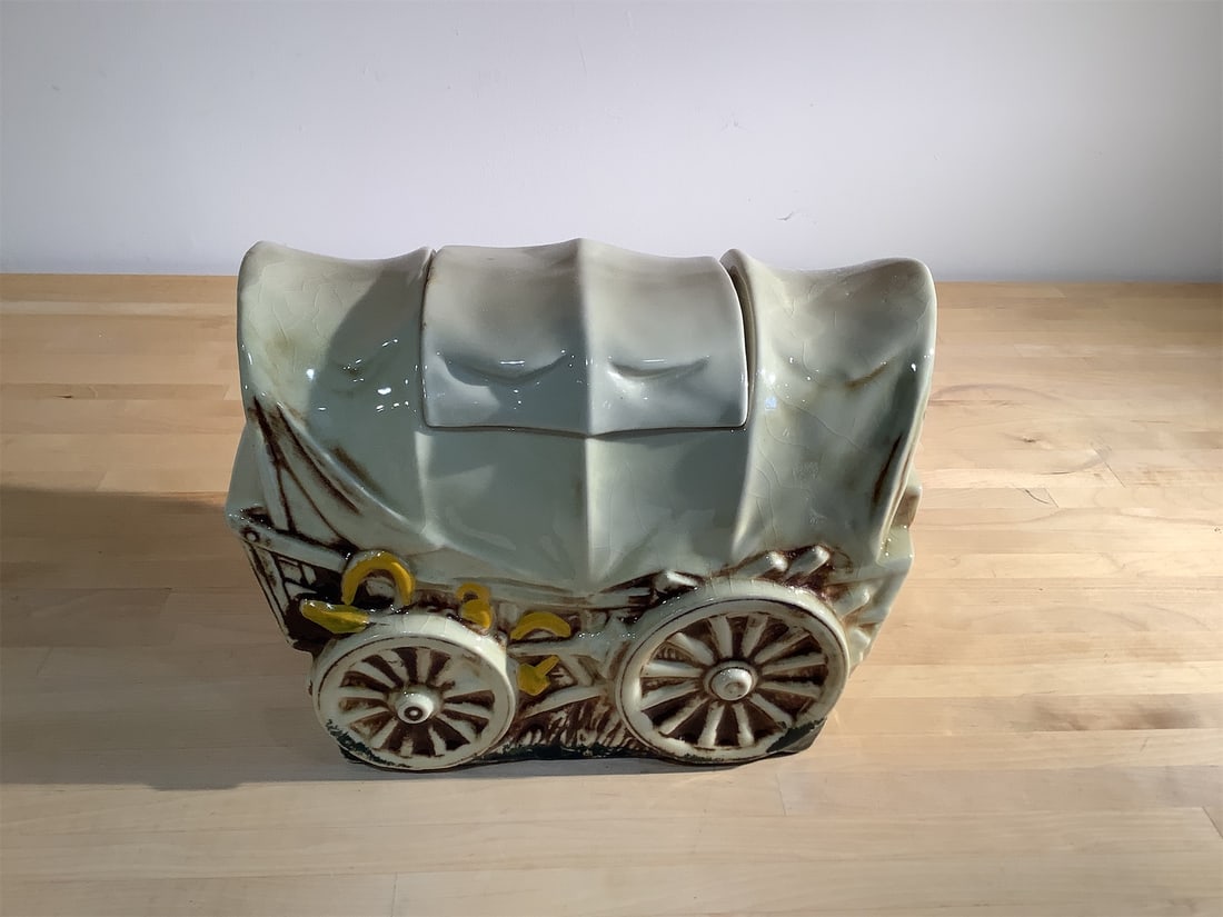 Vintage McCoy Covered Wagon Cookie Jar: Vintage McCoy covered wagon cookie jar is a charming piece that adds a unique touch to any kitchen or collection. The jar features a detailed design resembling a classic covered wagon, complete with