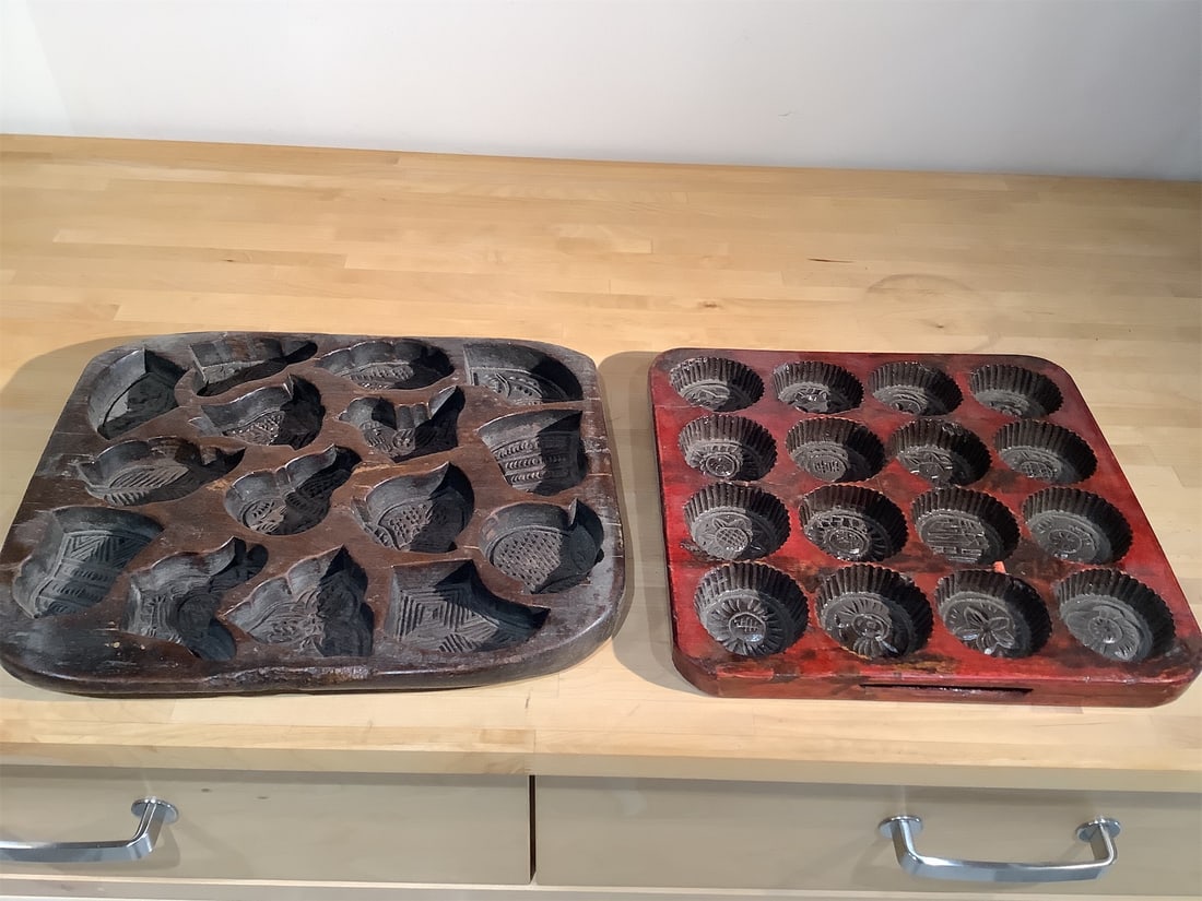 Vintage Wooden Cookie Molds: Two vintage wooden cookie molds that showcase intricate designs, perfect for collectors or baking enthusiasts. One mold is designed with a variety of motifs, including birds and decorative patterns,