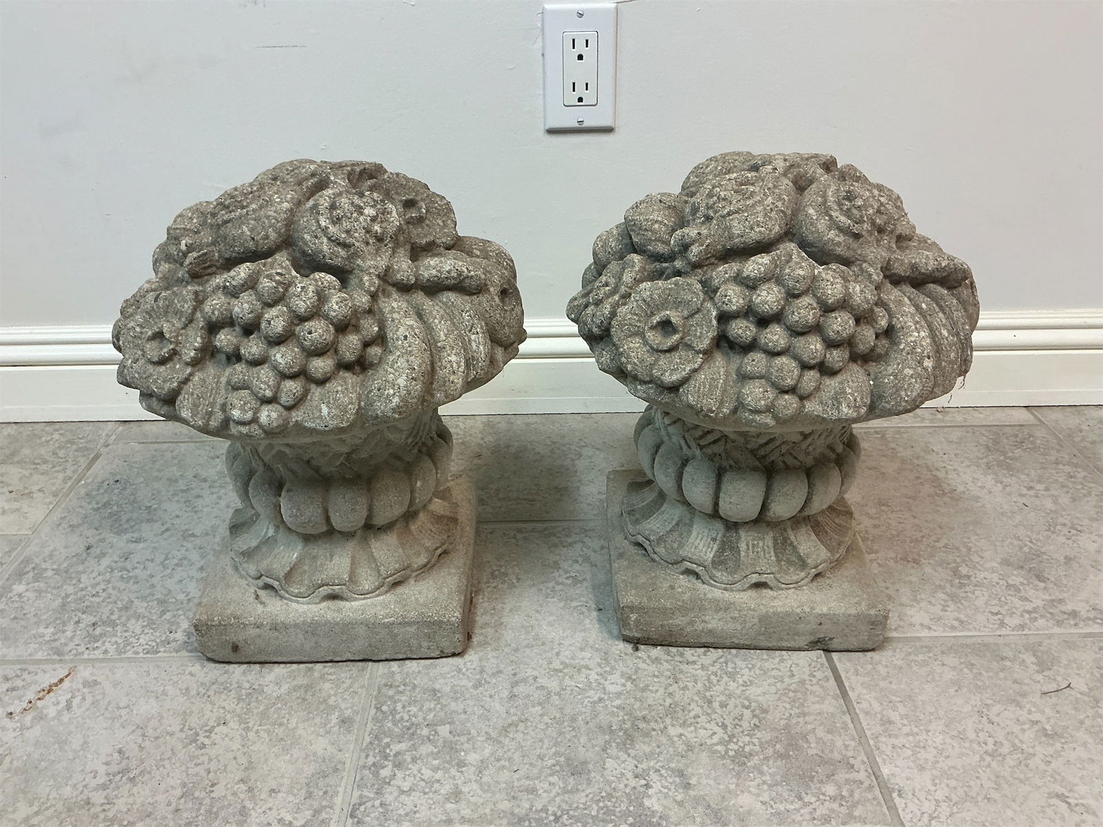 Pair of cast cement fruit basket finials: Pair of cast cement finials designed in the style of fruit baskets. Each finial showcases a beautifully detailed arrangement of various fruits and flowers, adding a classic touch to any outdoor or ind