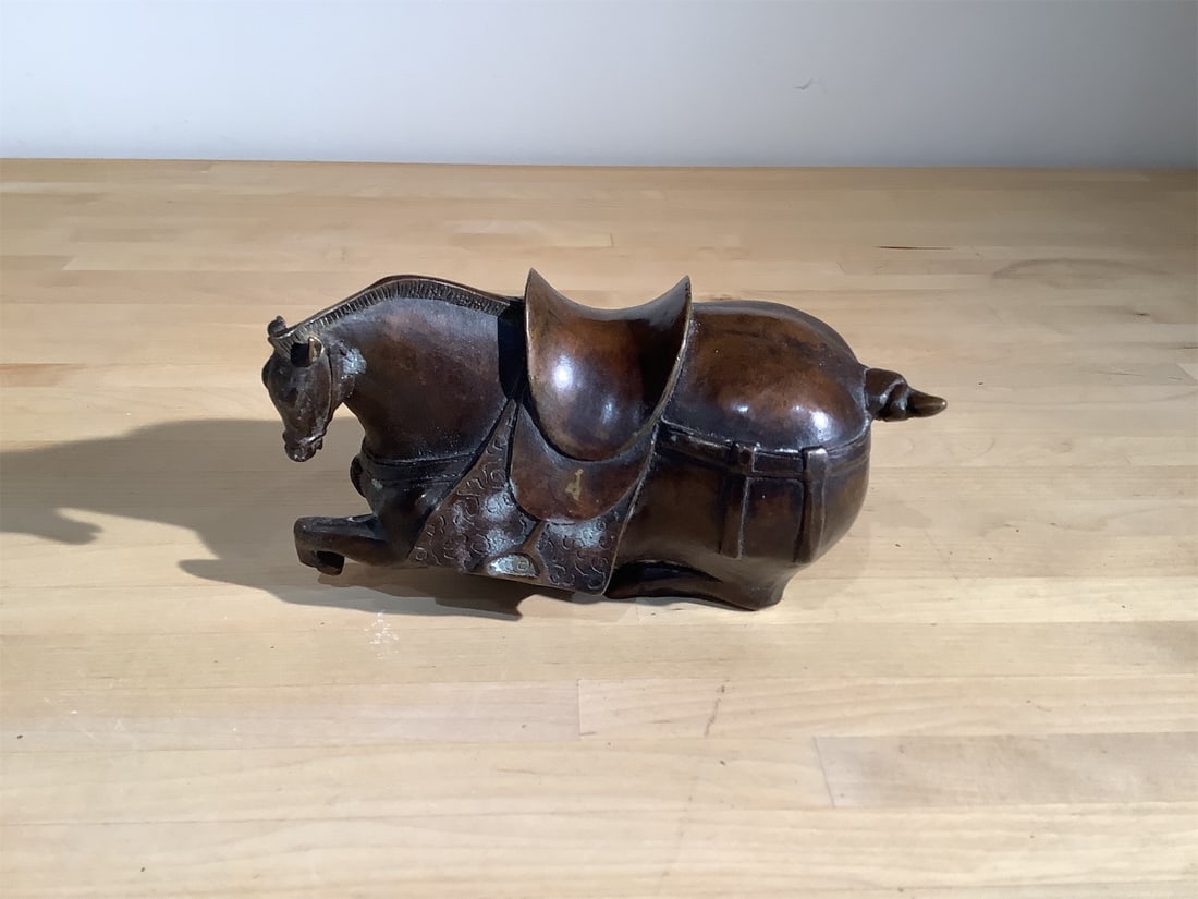 Chinese Bronze Recumbent Horse Statue: Intricately crafted Chinese bronze statue features a recumbent horse, showcasing exquisite artistry and attention to detail. The horse is depicted in a resting position, adorned with a detailed